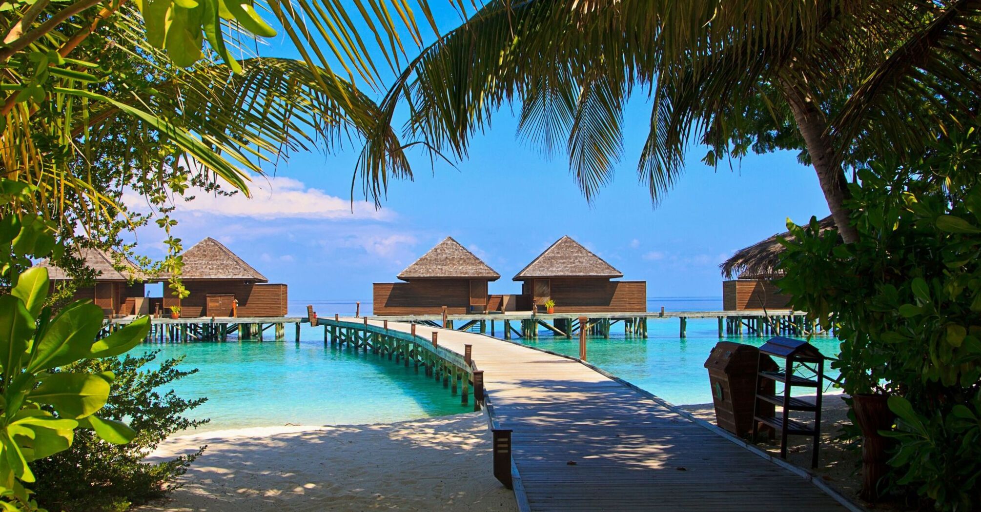 Beach villas in the Maldives with a wooden walkway