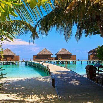 Beach villas in the Maldives with a wooden walkway
