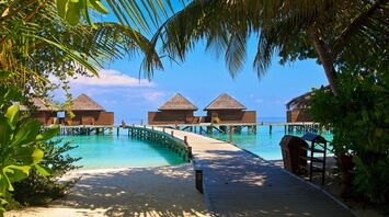 Beach villas in the Maldives with a wooden walkway