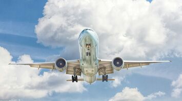 Airplane flying against a backdrop of cloud