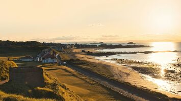 Sunset view of North Berwick coastline with buildings and beach in the distance