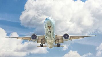 gray and white airplane on flight near clear blue sky