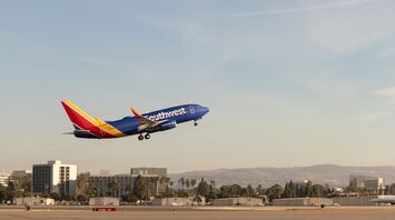a large jetliner flying through a blue sky
