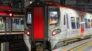 Transport for Wales train at platform 13 at night with a driver in the cabin, ready to depart