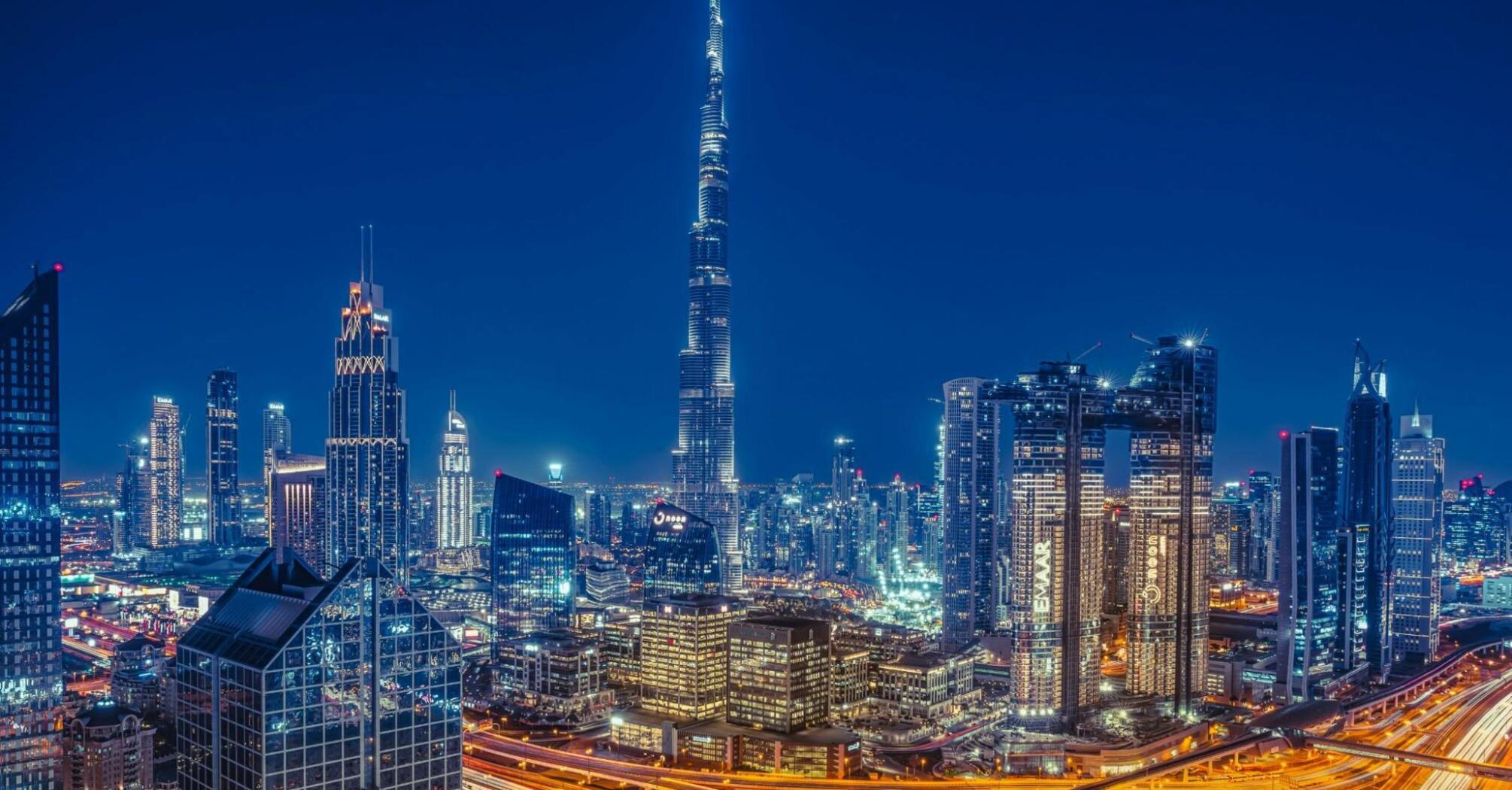 Night city view of Dubai with the heist buildings of the world