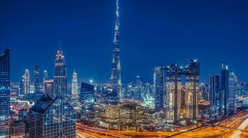 Night city view of Dubai with the heist buildings of the world