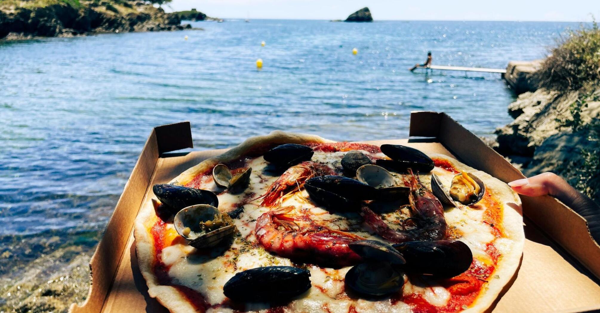 Pizza with seafood on the beach of Costa Brava