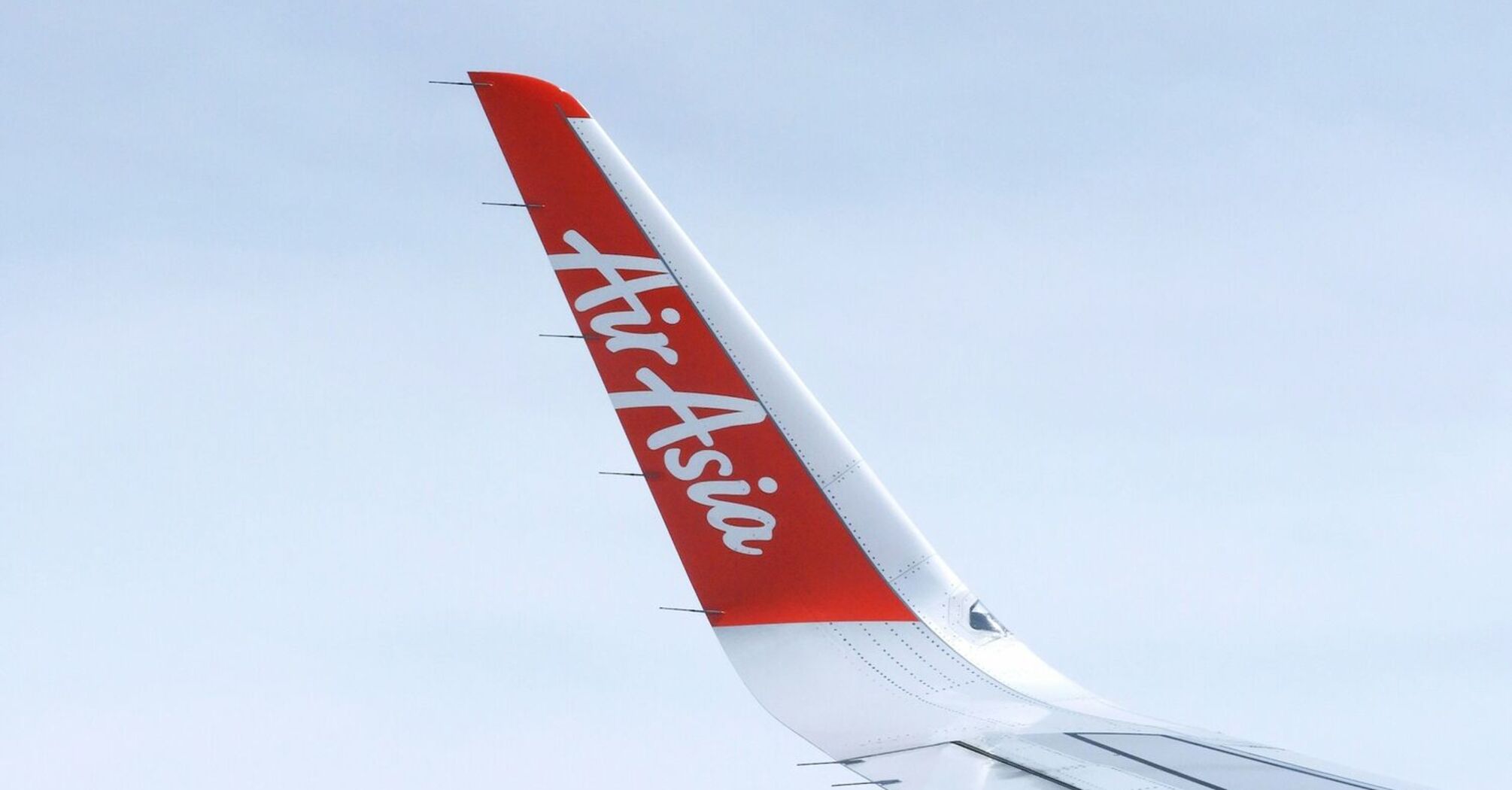 AirAsia airplane wing with logo
