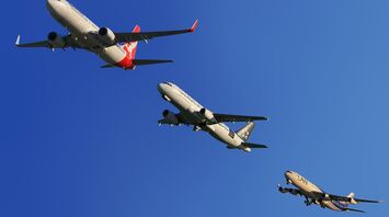 Three airplanes from different airlines in the sky