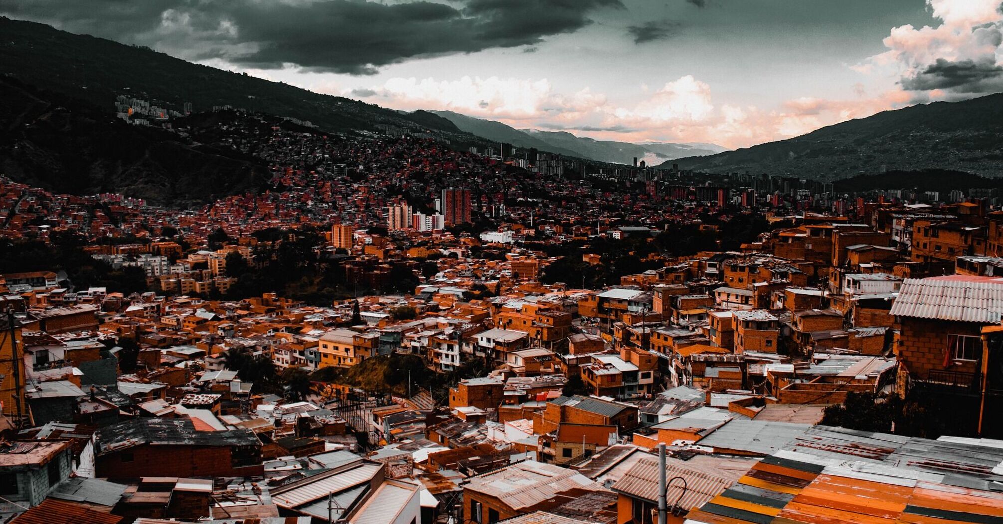 Cityscape of Medellin with dense housing and mountainous background