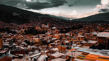 Cityscape of Medellin with dense housing and mountainous background