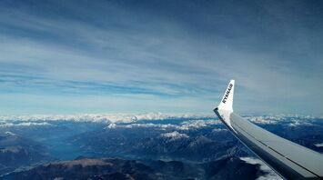 Ryanair airplane wing over mountain landscape