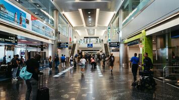 a group of people walking through an airport