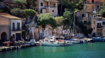 Scenic view of boats docked by coastal houses in Majorca