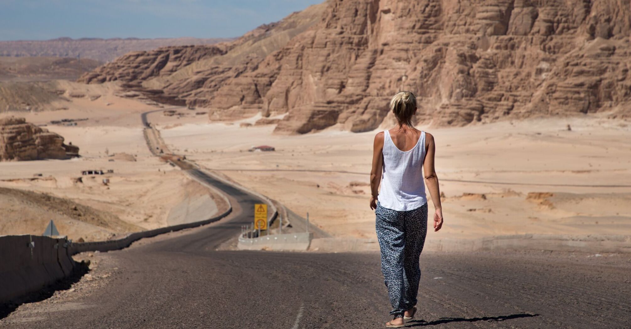 Traveler walking along a desert road in Egypt