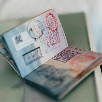 Open passport with various visa stamps on pages