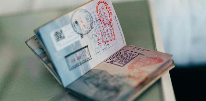 Open passport with various visa stamps on pages