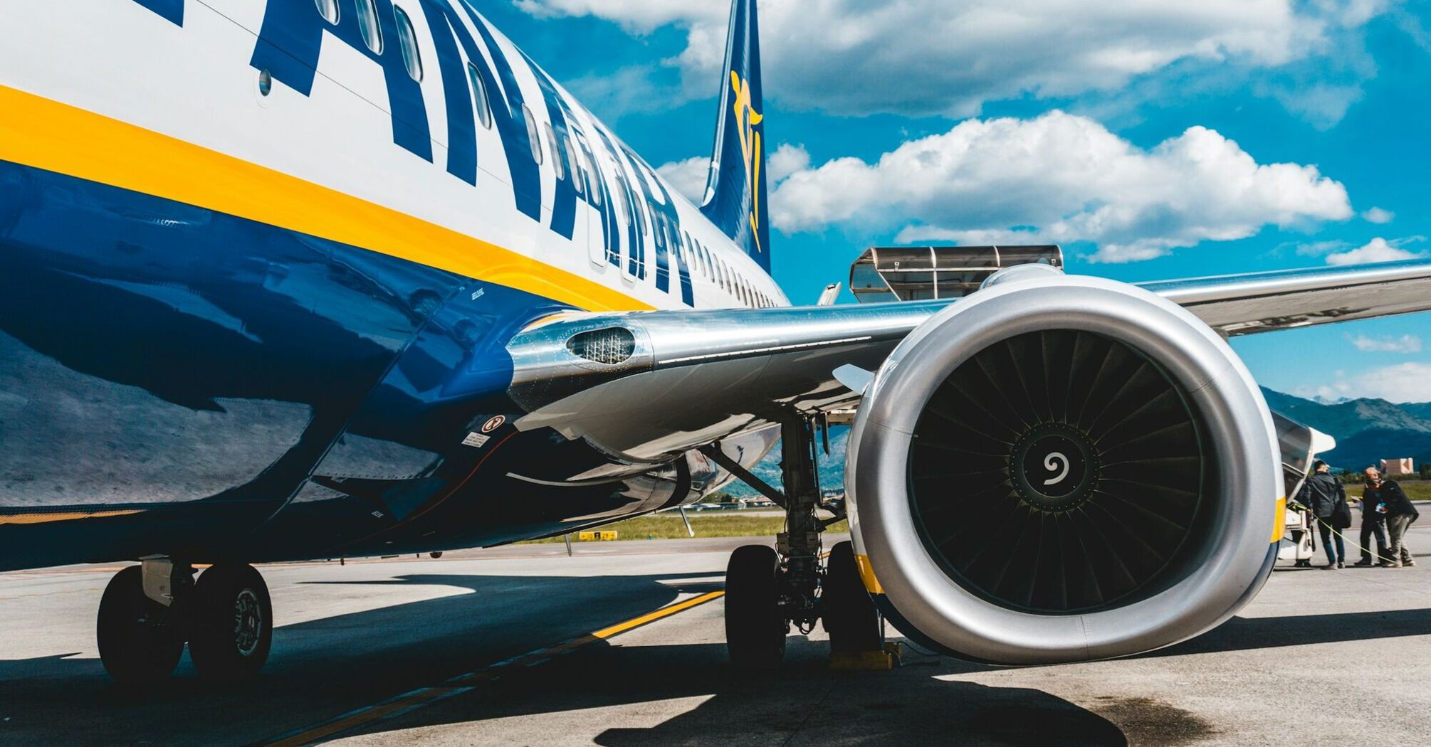 A Ryanair airplane parked on the tarmac under a blue sky