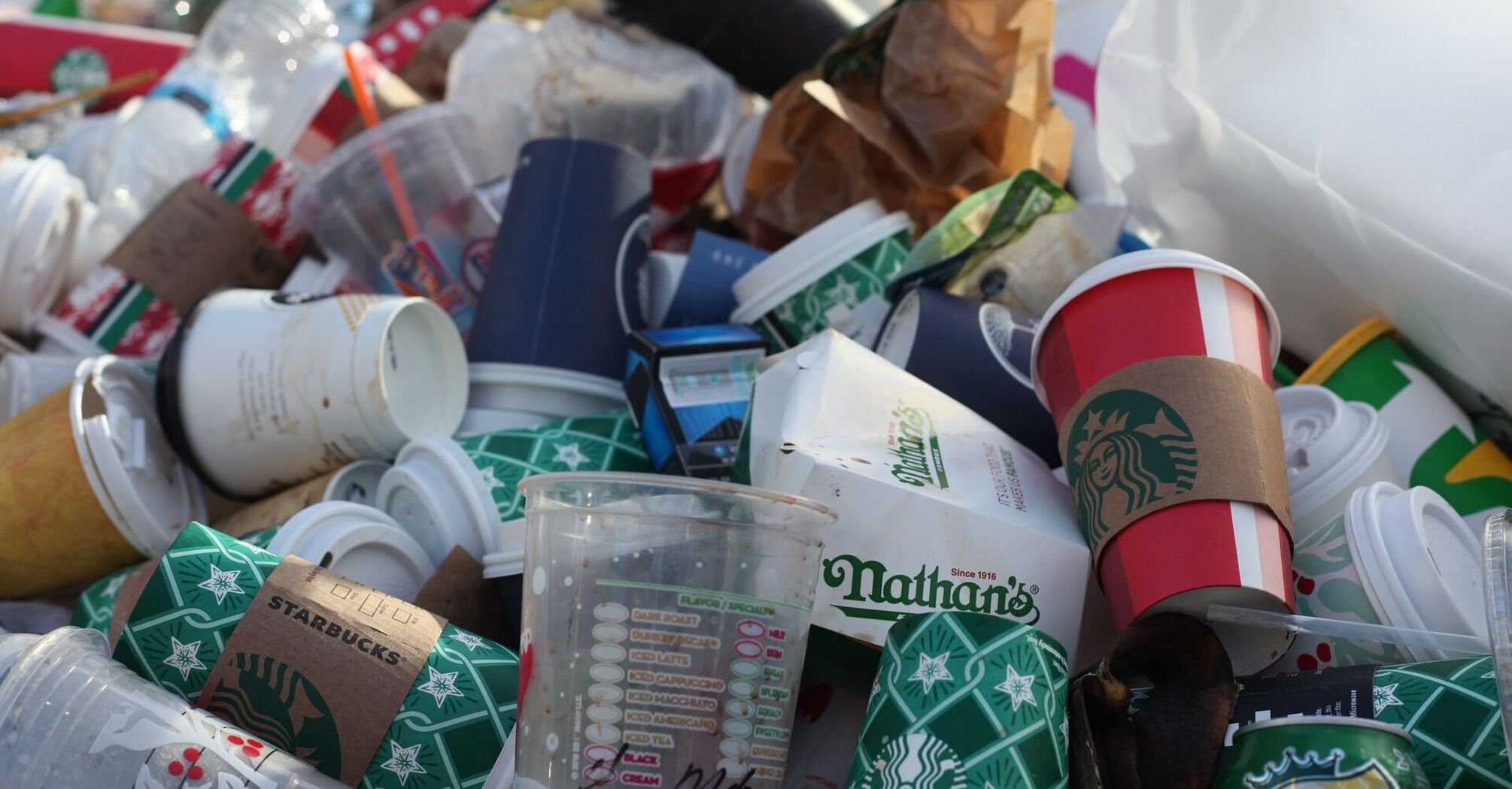 A pile of discarded coffee cups and food containers