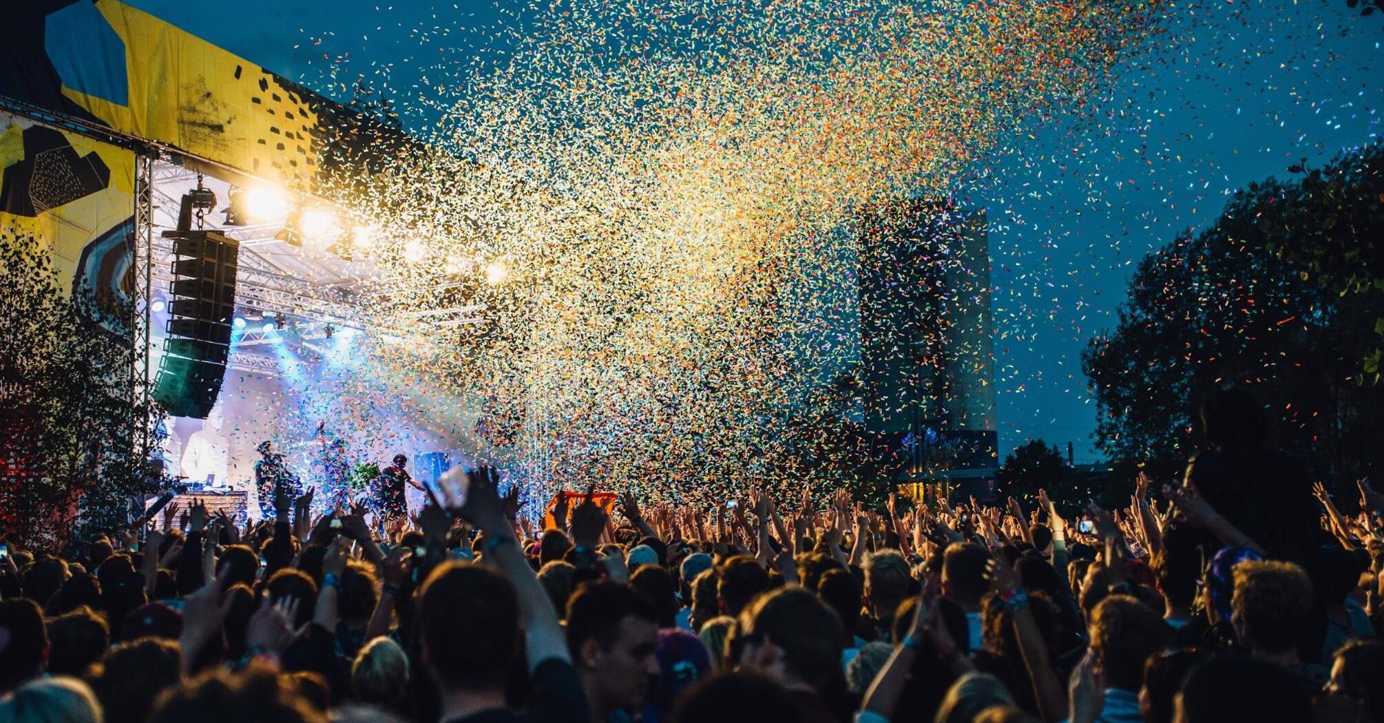 Large outdoor concert with confetti at night