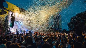 Large outdoor concert with confetti at night