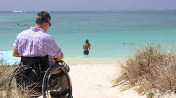 Man in a wheelchair at a beach