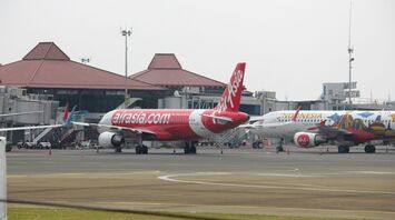 a couple of airplanes that are on a runway