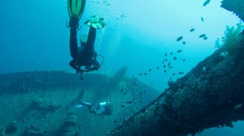 man wearing scuba diving swimming in water