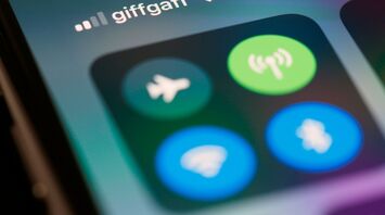 lose-up of a smartphone screen showing Wi-Fi and airplane mode icons