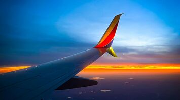 View from an airplane window during sunset with Southwest Airlines wing