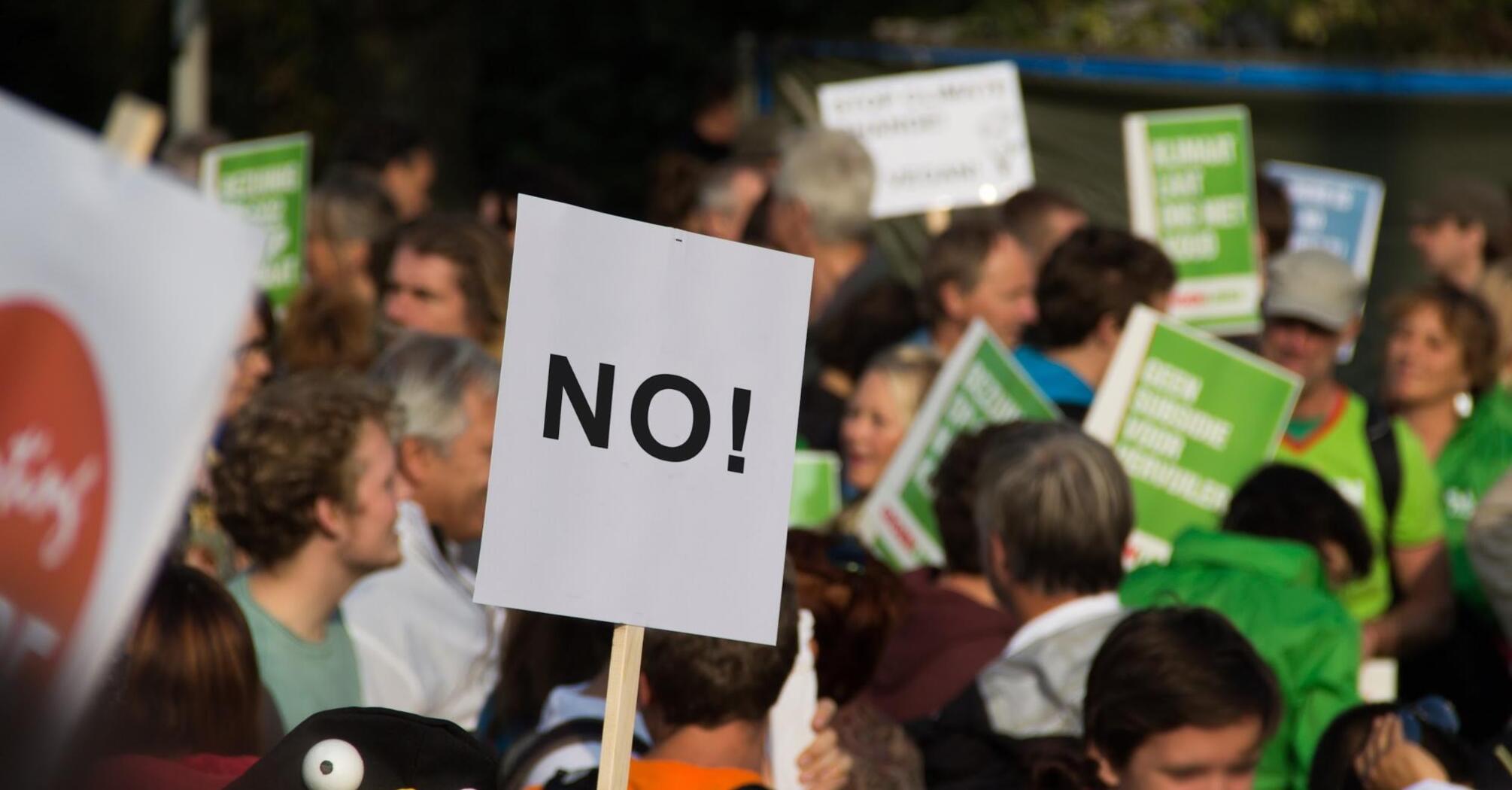 Protest with participants holding various signs