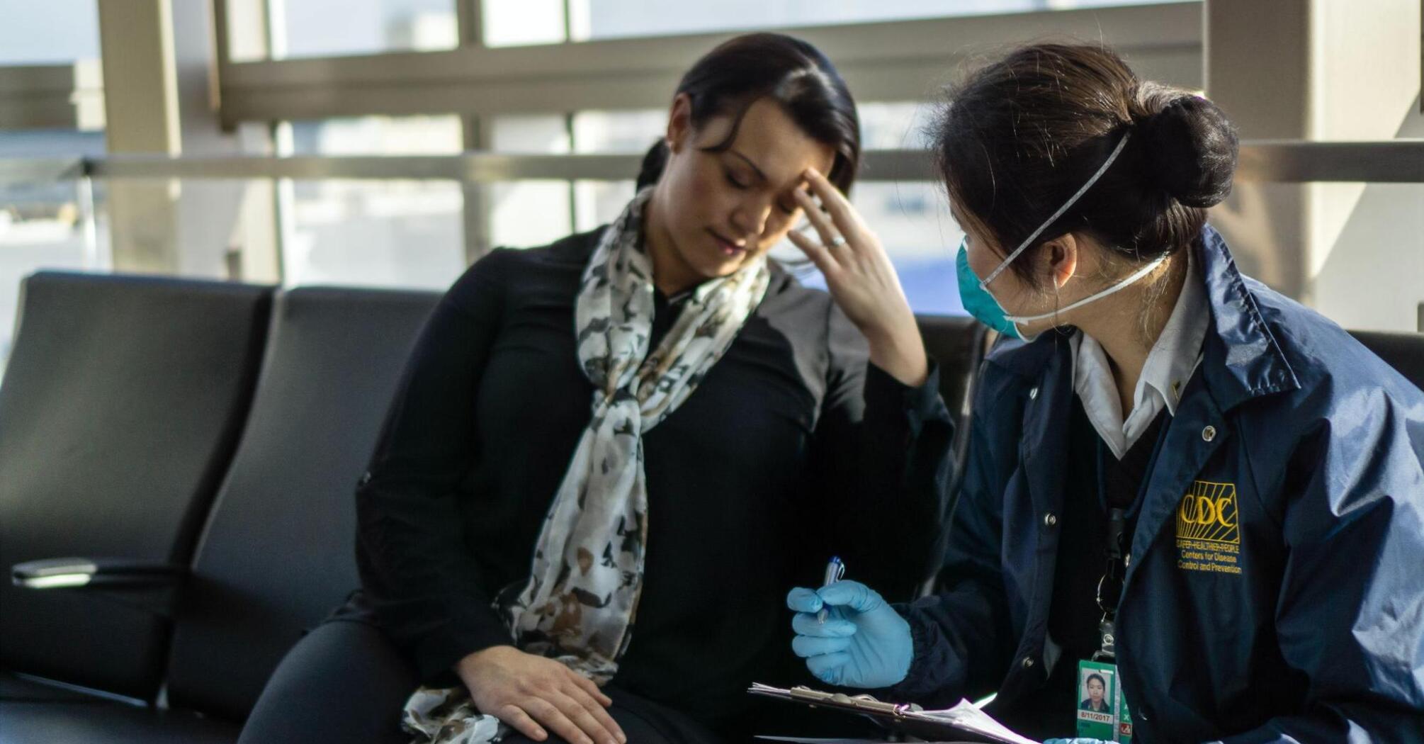 A woman receives medical care from a CDC employee