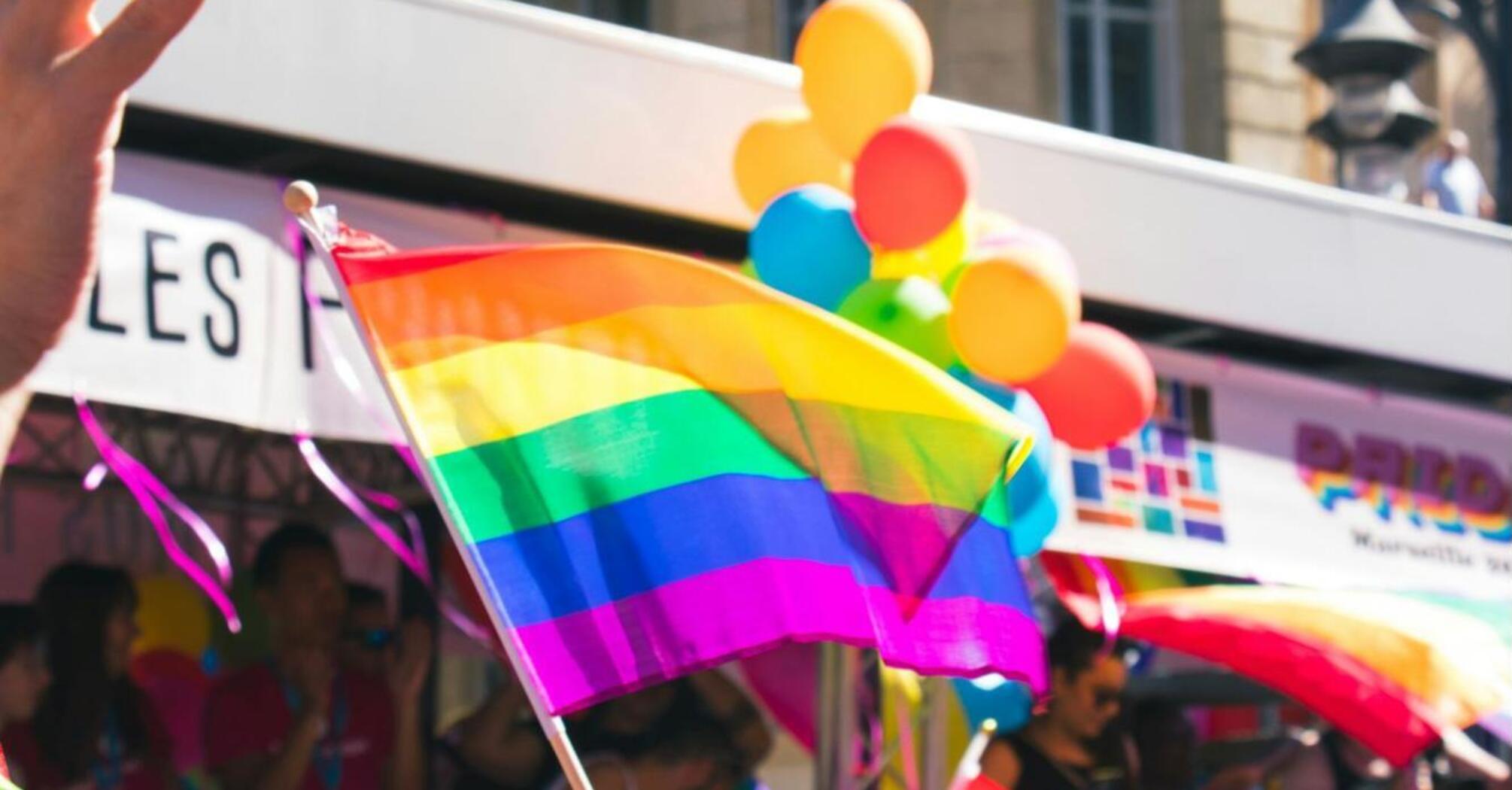 People with rainbow flags at the Pride Parade