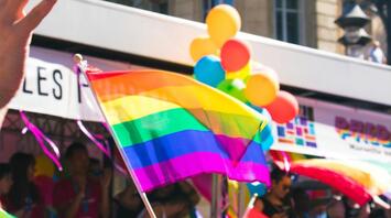 People with rainbow flags at the Pride Parade