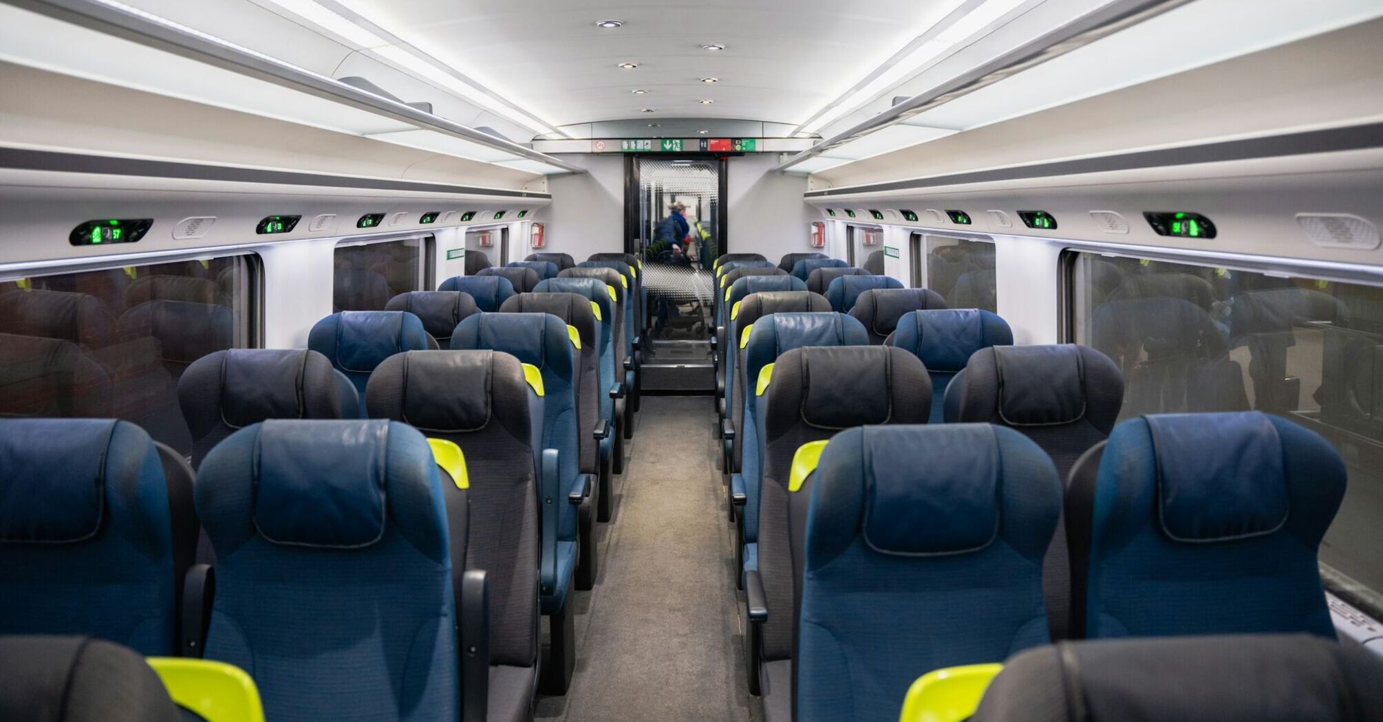 Interior of an empty Eurostar train carriage with rows of seats