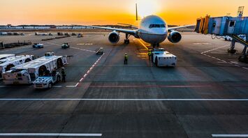 gray airplane on parking