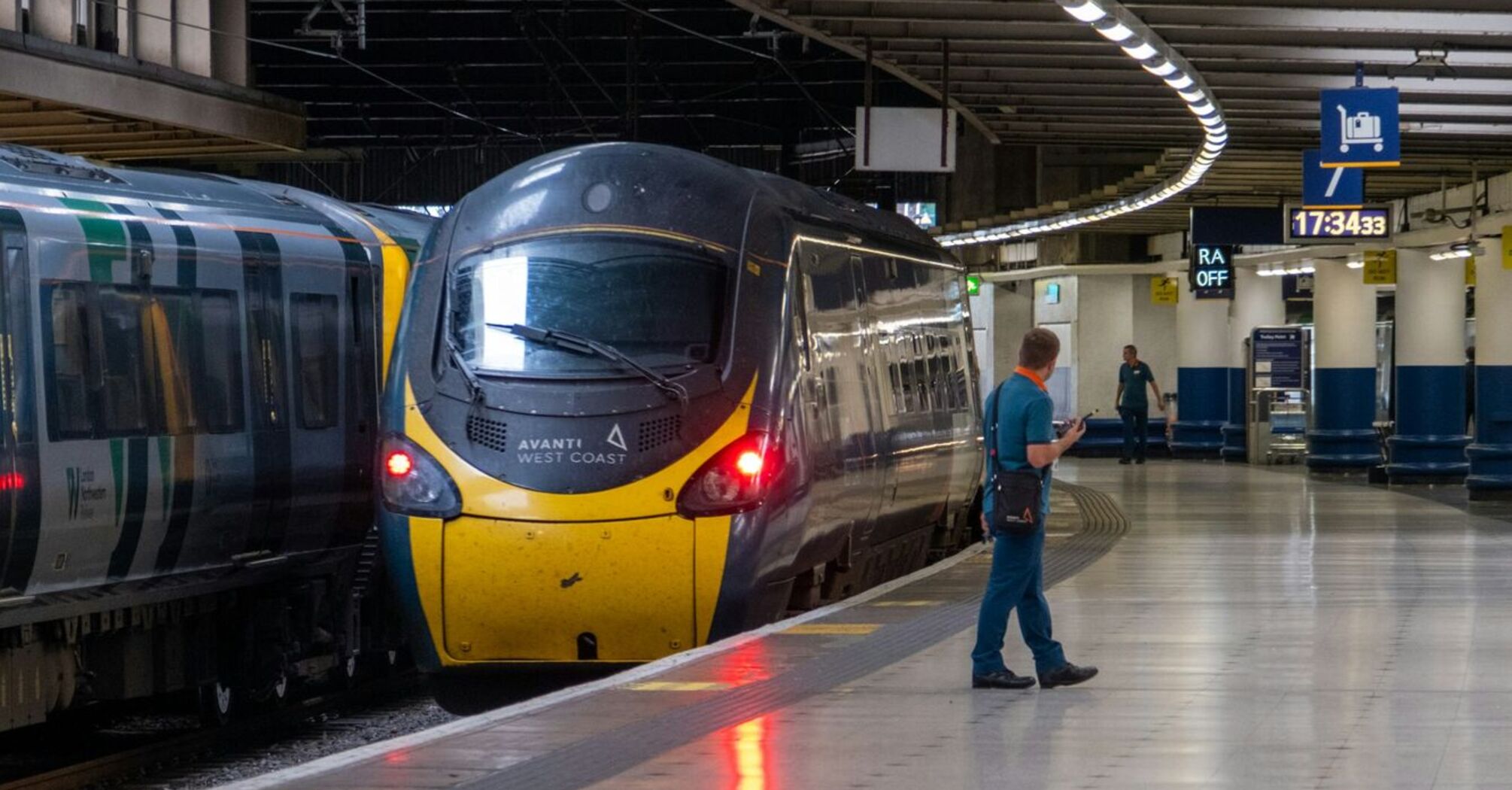 A modern train at a nearly empty London Euston station platform