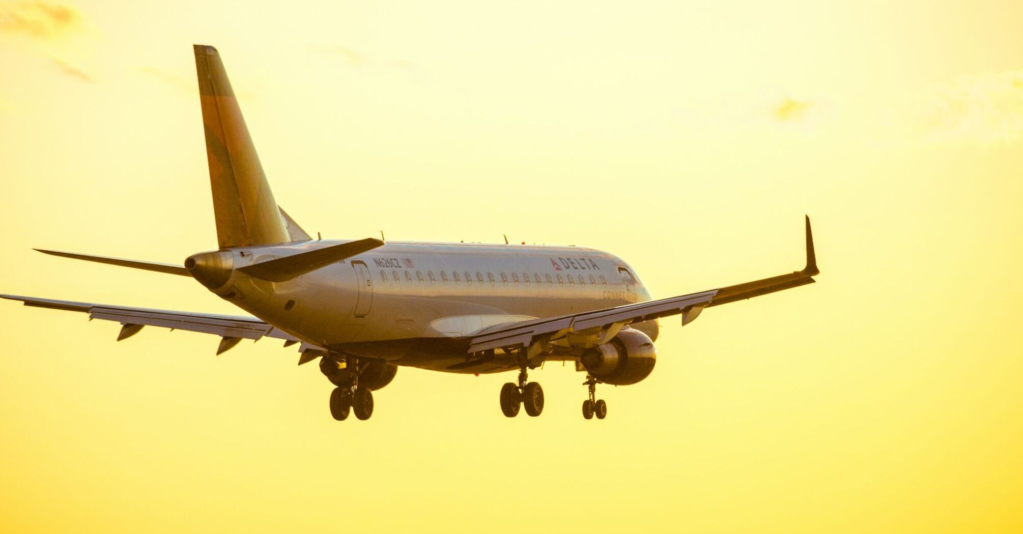 Delta Air Lines plane landing at sunset