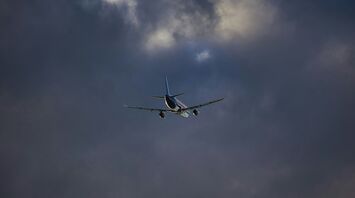 Airplane flying through stormy clouds