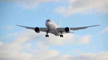 white passenger plane in mid air during daytime