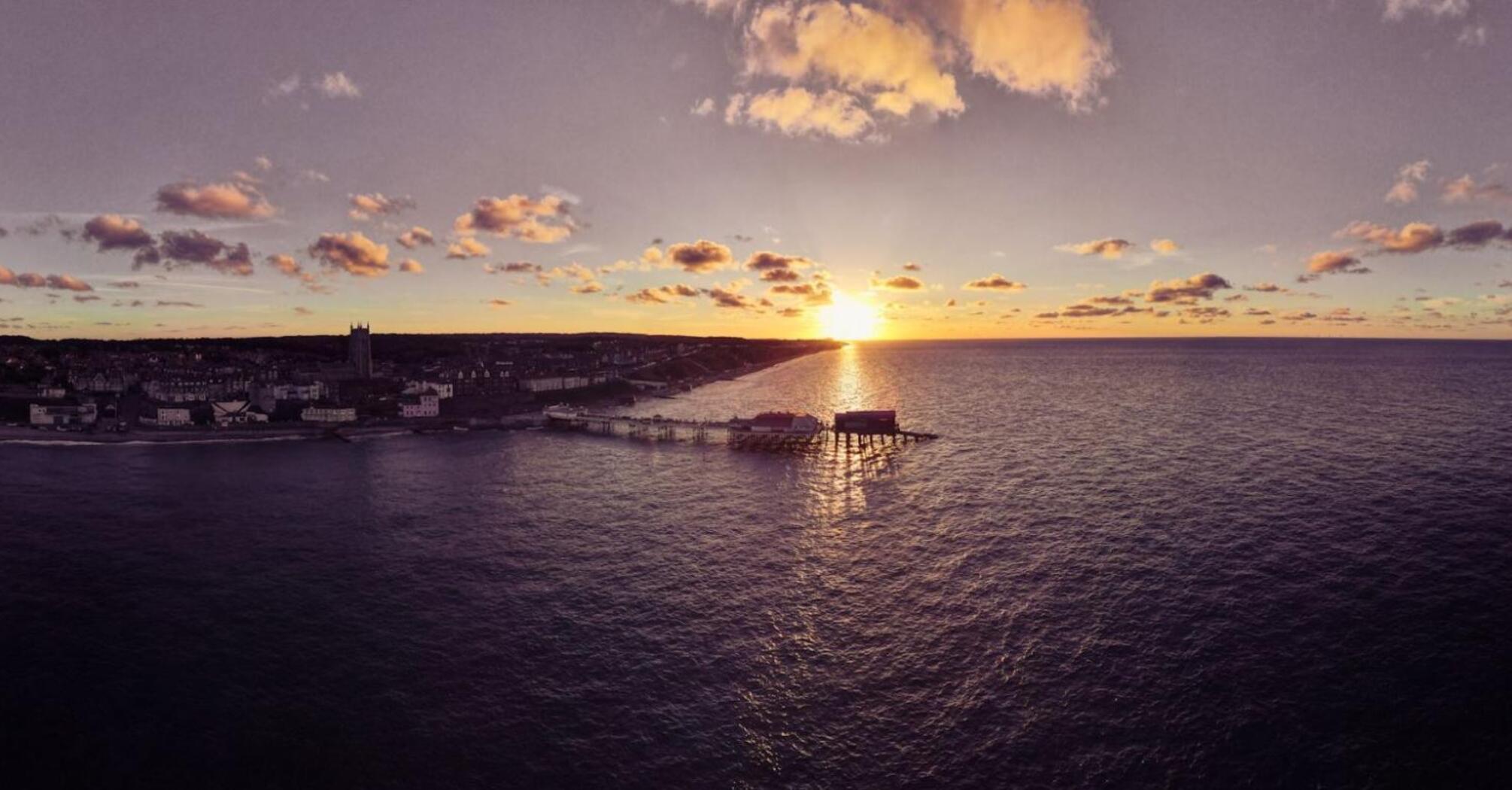 A picturesque sunset over Cromer with the pier and coastline visible