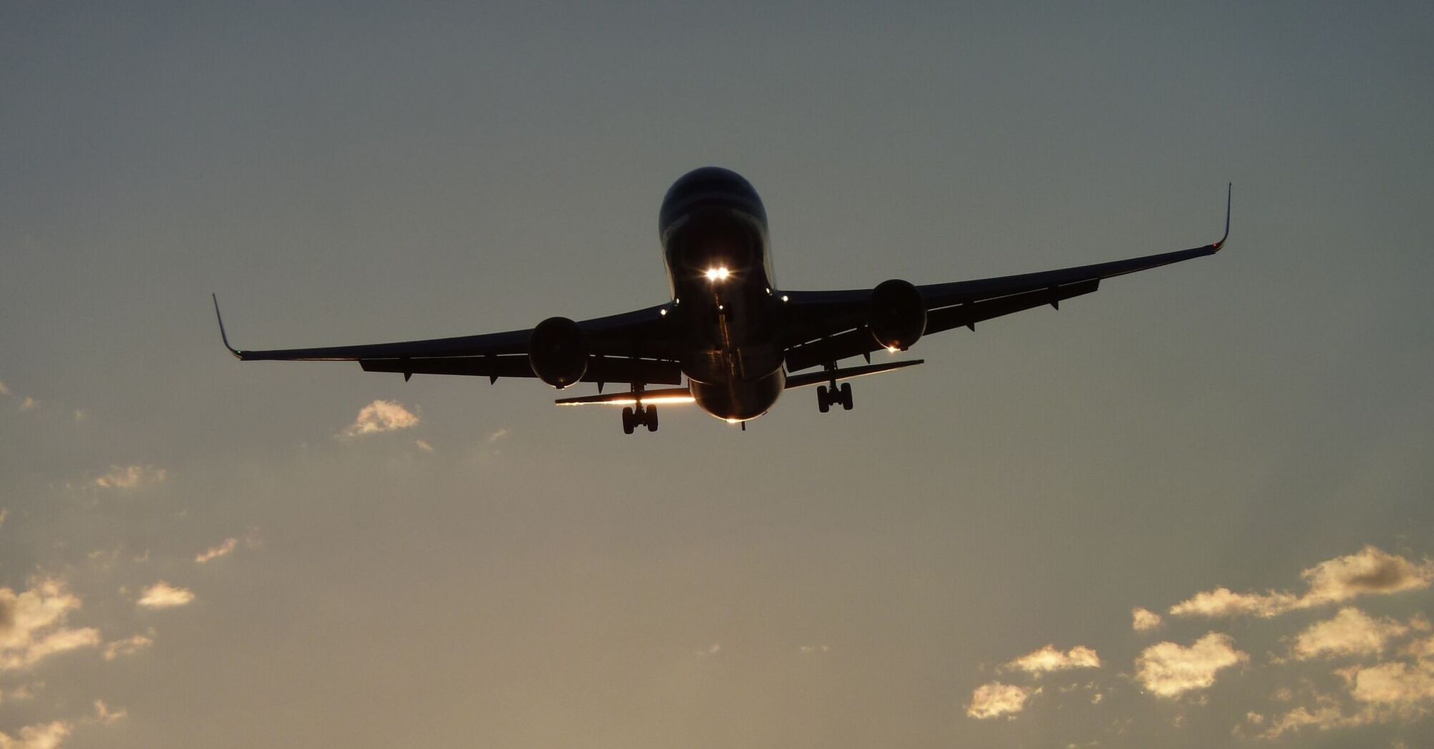 Airplane flying into the sunset