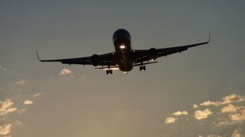 Airplane flying into the sunset