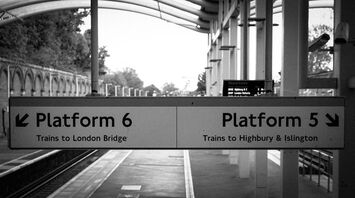 Train platform signs at a Crystal Palace railway station indicating directions to London Bridge and Highbury & Islington