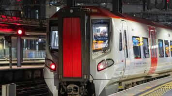 A Transport for Wales train at platform at a railway station in Manchester during the night