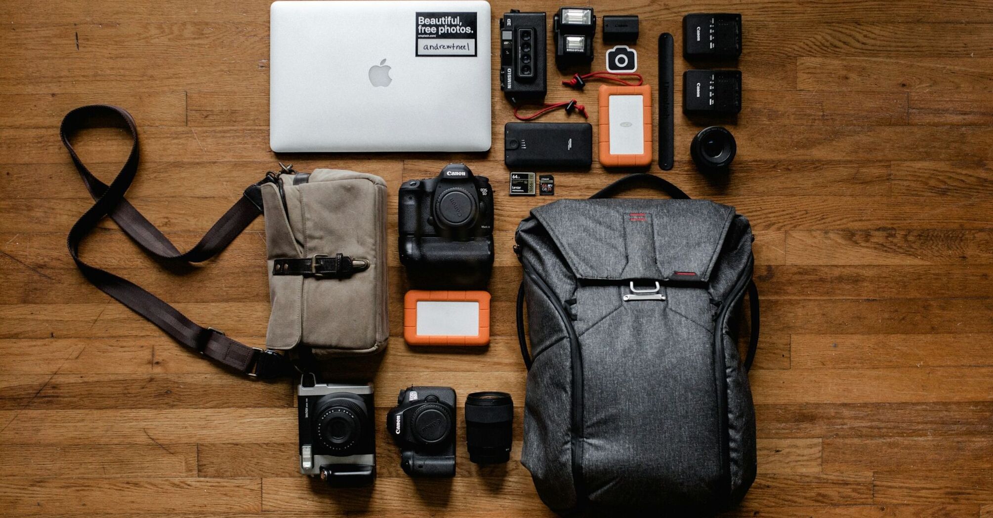 Travel and photography gear, including a backpack, camera, and accessories