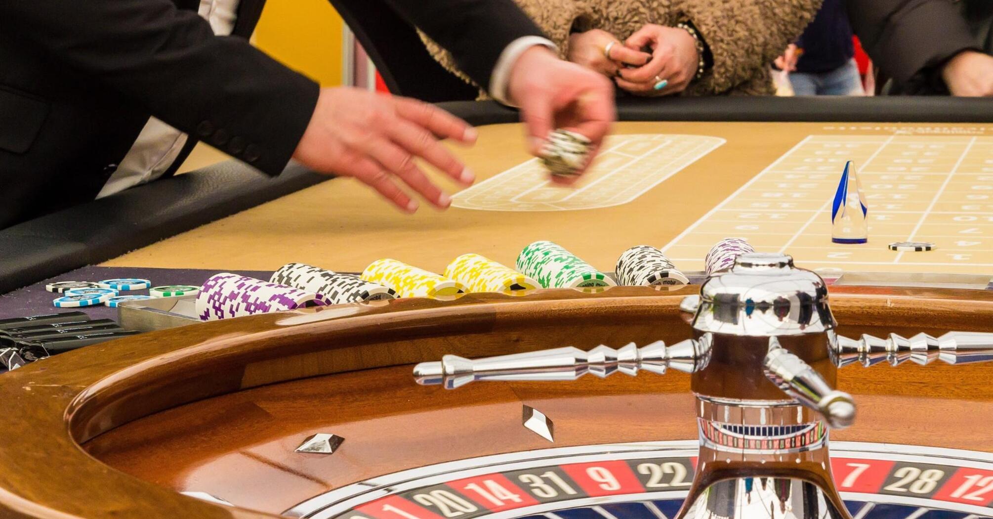 Dealer placing chips on the roulette table in a casino