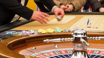 Dealer placing chips on the roulette table in a casino
