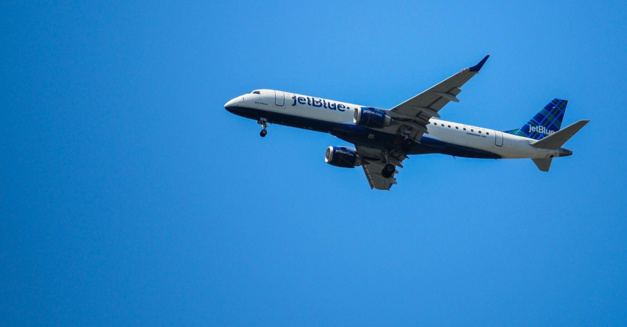 a large jetliner flying through a blue sky