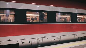 group of people inside red and gray train